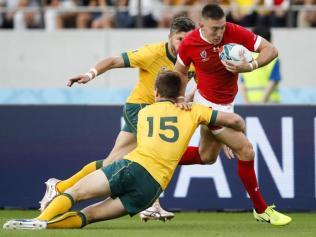 Wales' wing Joshua Adams is tackled by Australia's full back Dane Haylett-Petty 