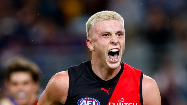 Nate Caddy of the Bombers celebrates a goal at the GABBA in round 12. Photo by Russell Freeman/AFL Photos via Getty Images.