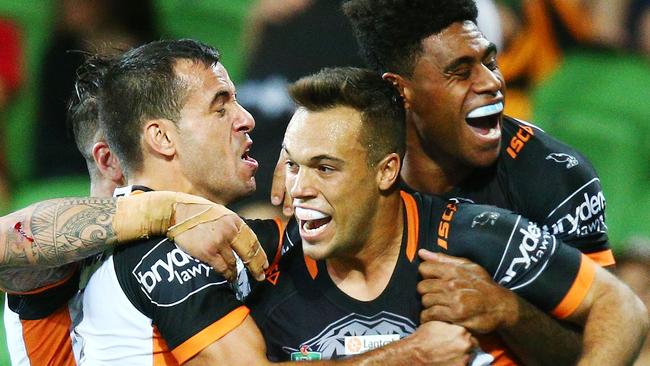 The Wests Tigers celebrate Luke Brooks’ winning try against the Storm.