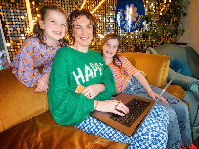 How Australians can save on Black Friday sales. Natalie Jarvis and her children Matilda (9) and Stella (7) online to score a bargain during Black Friday sales. Picture: Tony Gough