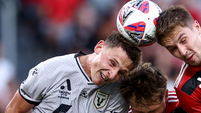 SYDNEY, AUSTRALIA - JANUARY 01: James Temelkovski and Alexander Bonetig of the Wanderers compete with Oliver Jones of the Bulls during the round 11 A-League Men match between Western Sydney Wanderers and Macarthur FC at CommBank Stadium, on January 01, 2025, in Sydney, Australia. (Photo by Brendon Thorne/Getty Images)