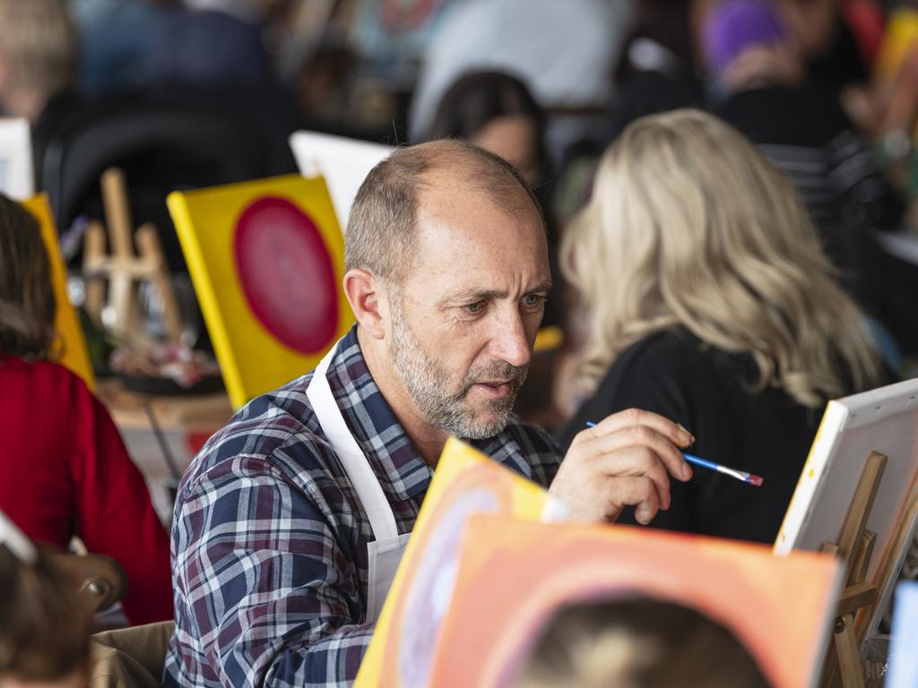 Jeff Lyndon participates in the World's Largest Paint and Sip Luncheon for Momentum Mental Health at Clifford Park racecourse, Friday, June 21, 2024. Picture: Kevin Farmer