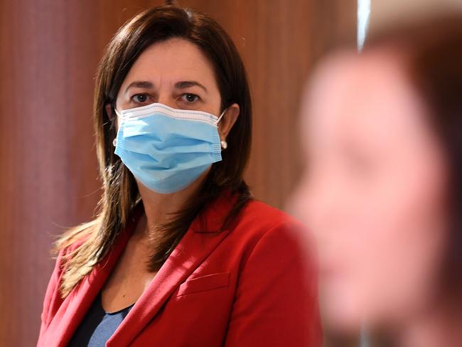 BRISBANE, AUSTRALIA - NewsWire Photos - JULY 7, 2021.Queensland Premier Annastacia Palaszczuk listens to Health Minister Yvette D'Ath sas she peaks during a media conference to provide a Covid update.Picture: NCA NewsWire / Dan Peled