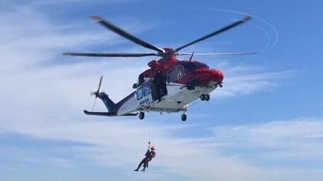 Marine rescue arrives to get the boy to safety.