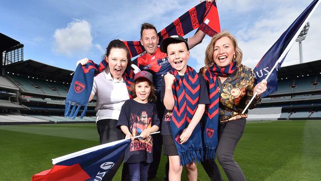 Karina Childs, Eliza Anderson, 5, Mick Walker, Tom Anderson, 8, and Catherine Picioane are excited to celebrate the Dees’ win. Picture: Nicki Connolly