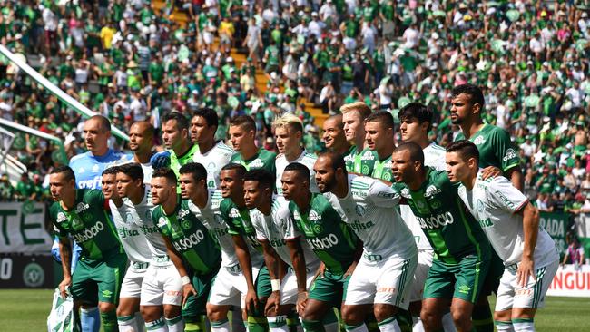The new players of Chapecoense pose before a friendly football match against Palmeiras.