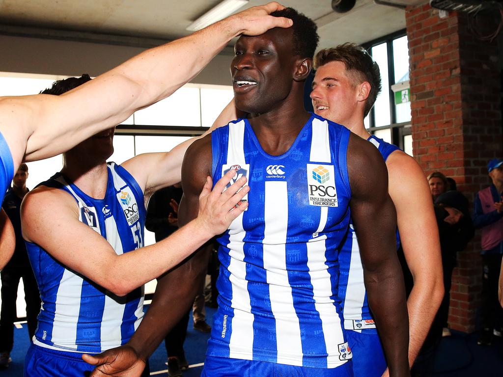 Majak Daw is congratulated by teammates after his first game back.