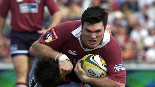 Daniel Herbert (ball) surges over top of Scott Staniforth during Qld Reds vs NSW Waratahs Super 12 game at Ballymore. Picture: Anthony/Weate. Rugby Union A/CT sport action