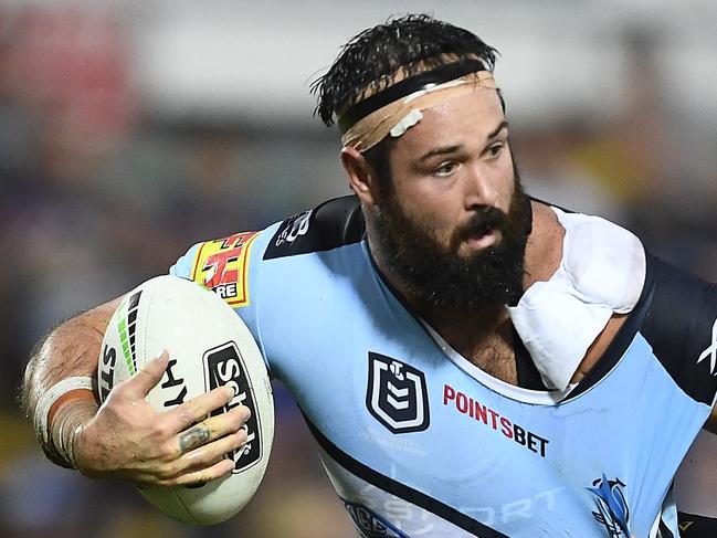 TOWNSVILLE, AUSTRALIA - MARCH 30: Aaron Woods of the Sharks is tackled by Matt Scott and  Jordan McLean of the Cowboys of the Cowboys during the round three NRL match between the North Queensland Cowboys and the Cronulla Sharks at 1300SMILES Stadium on March 30, 2019 in Townsville, Australia. (Photo by Ian Hitchcock/Getty Images)