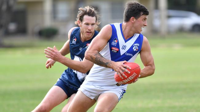 Athelstone’s Jake Westover is chased by Henley’s Michael Gautesen during an Adelaide Footy League match. Picture: AAP/Keryn Stevens