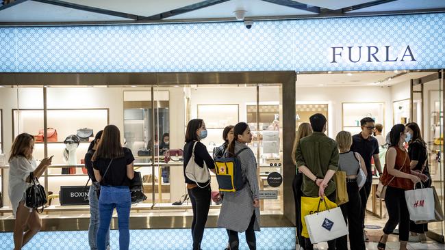 Shoppers formed lines outside some stores, including Furla. Picture: Monique Harmer