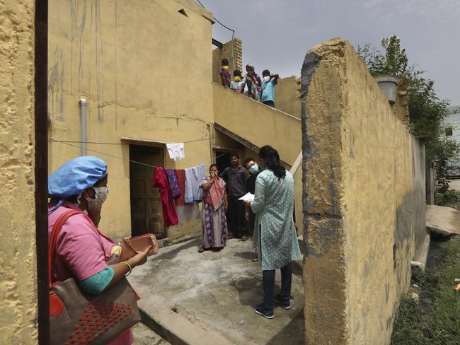 An Indian government school teacher takes a health survey in New Delhi, India, as coronavirus cases in the country continue to grow. Picture: AP