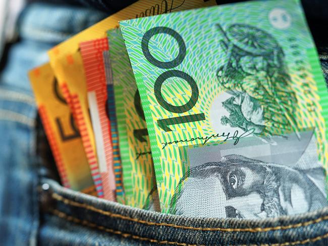 Australian cash money in mans jeans pocket, close up.