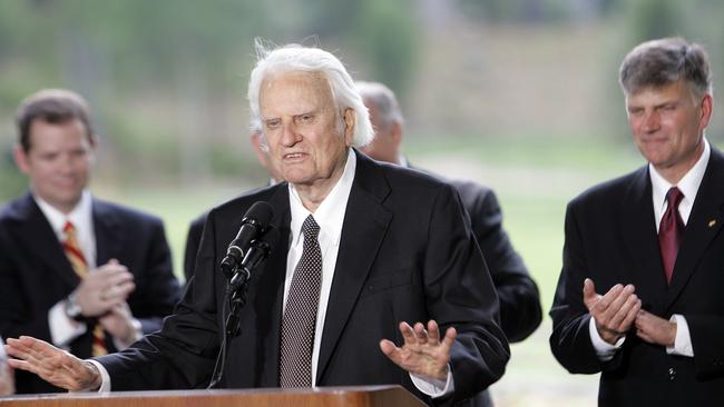 Billy Graham speaks as his son Franklin Graham, right, listens during a dedication ceremony for the Billy Graham Library in 2007. Picture: AP