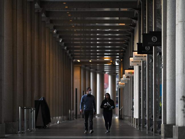 People walk past a row of closed stores and restaurants at Sydney’s Circular Quay. Picture: AAP