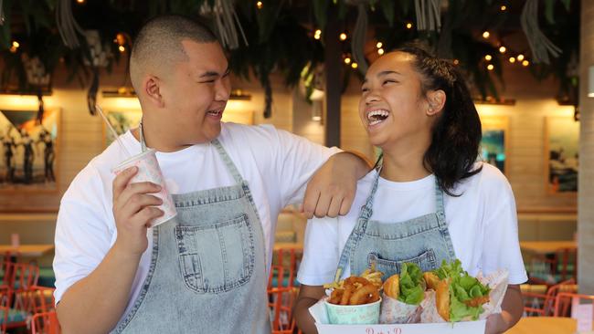 Joshua Aguilar and Ysabella Nieves pose for a photo at Betty's Burgers today, August 4, 2018. Betty's Burgers and Concrete Co. held its grand opening in Castle Towers Piazza today. (AAP Image/David Swift)