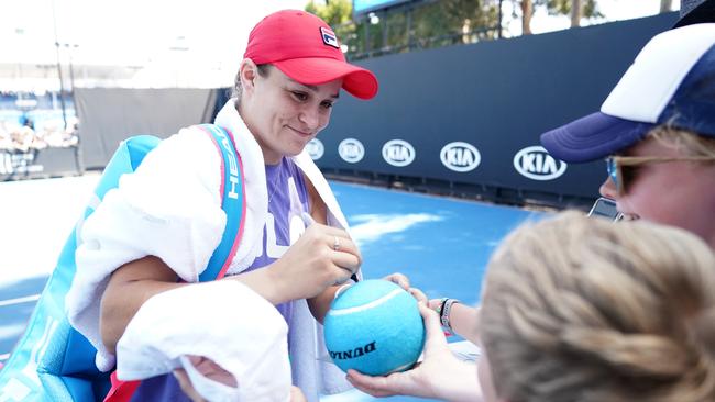 Team Barty surrounds the world No 1 after a practice session on Wednesday at the Australian Open tennis tournament. Picture: AAP