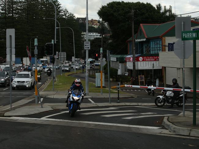 The same rider passes in front of the boom gate while the other motorcyclist is still waiting behind it. Picture: Annika Enderborg