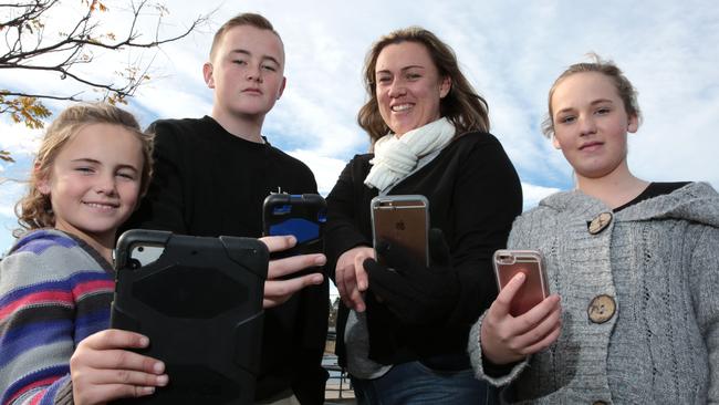 Paula Jones, of St Helens Park, with son Joshua (13), daughter Isabella (12) and niece Jasmine McFadden (8), who love playing Pokemon Go. Picture: Robert Pozo