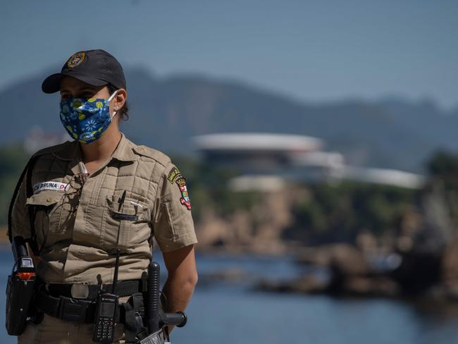 A municipal guard patrols the promenade of Icarai beach during the first day of lockdown due to the COVID-19 coronavirus, in Niteroi, Rio de Janeiro state. Picture: AFP