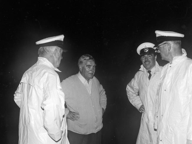 Premier Eric Reece with police officers at the scene on January 5, 1975.