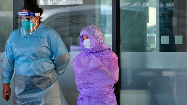 A quarantining hotel guest at the Holiday Inn near the airport is moved to a new location in Melbourne on Wednesday. Picture: AAP