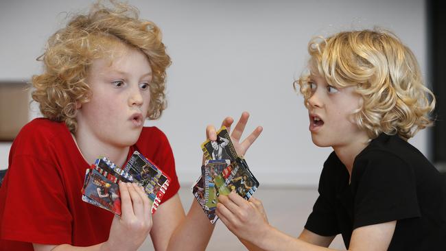 Brothers Stan 11 and Louis 8 trading footy cards. Picture: David Caird