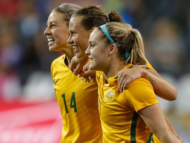 Alanna Kennedy, Emily Van Egmond and Ellie Carpenter celebrate after defeating the US 1-0.