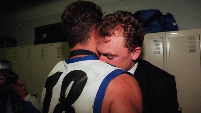 Wayne Carey and John Longmire after the 1996 grand final.