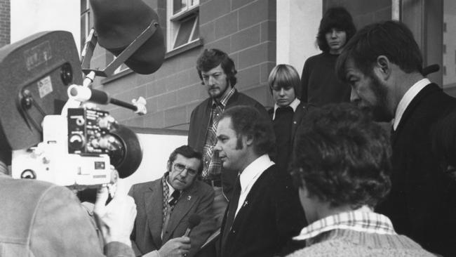 IN THE SPOTLIGHT: Julian Punch addresses the media outside the Hobart Magistrates Court on June 6, 1979, with supporters and the public looking on. The charges were withdrawn.