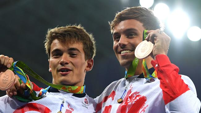 Bronze medallists Daniel Goodfellow and Tom Daley of Great Britain celebrate their win but only Daley was featured on the front pages of some papers. Picture: Laurence Griffiths/Getty Images.