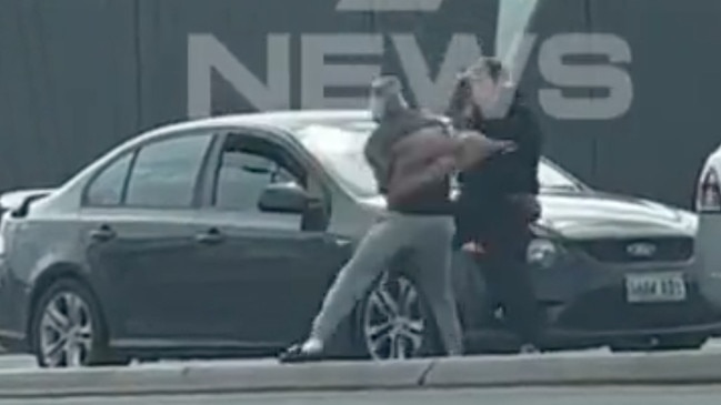 A road rage scuffle has been caught on camera on Port Road after one driver snatched the other’s car keys. Picture: 7NEWS