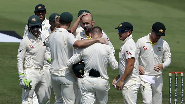 Nathan Lyon celebrates with teammates as his wicket haul grew yesterday. Picture: AP