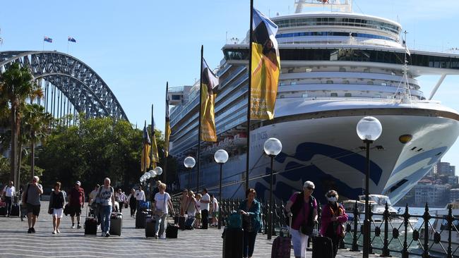 Cruise ship passengers disembark from the Carnival-owned owned Ruby Princess in Sydney on March 19. An inquiry is now under way into why passengers were allowed to disembark when some showed coronavirus symptoms. Picture: AAP