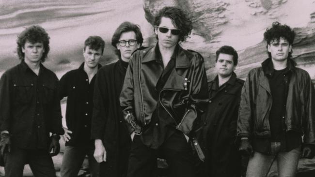The band dodged storms to shoot their promo shots at Bondi for the album release. Picture: Robert Mort