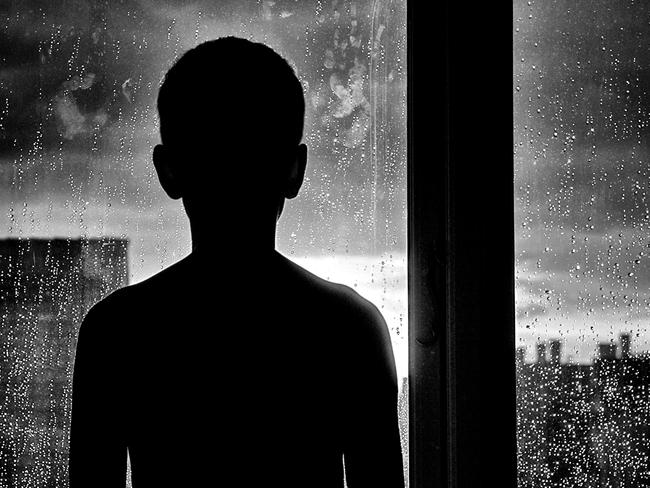 Silhouette of unrecognizable sad child. Generic iStock image.