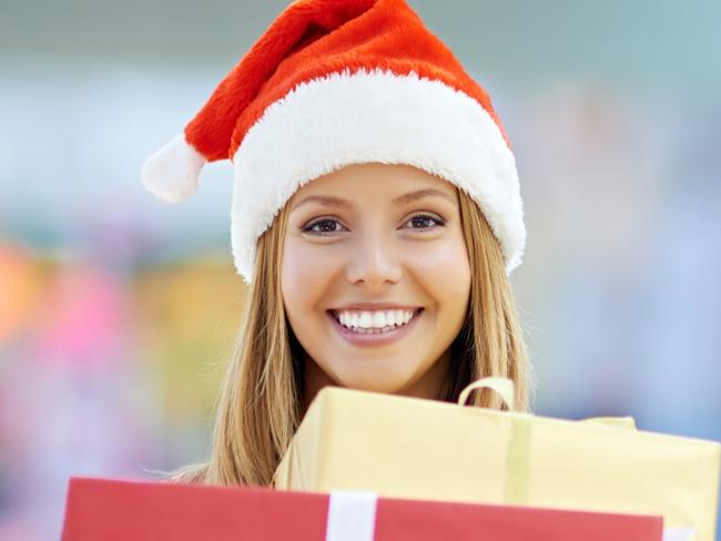 Portrait of a young woman holding gift boxes