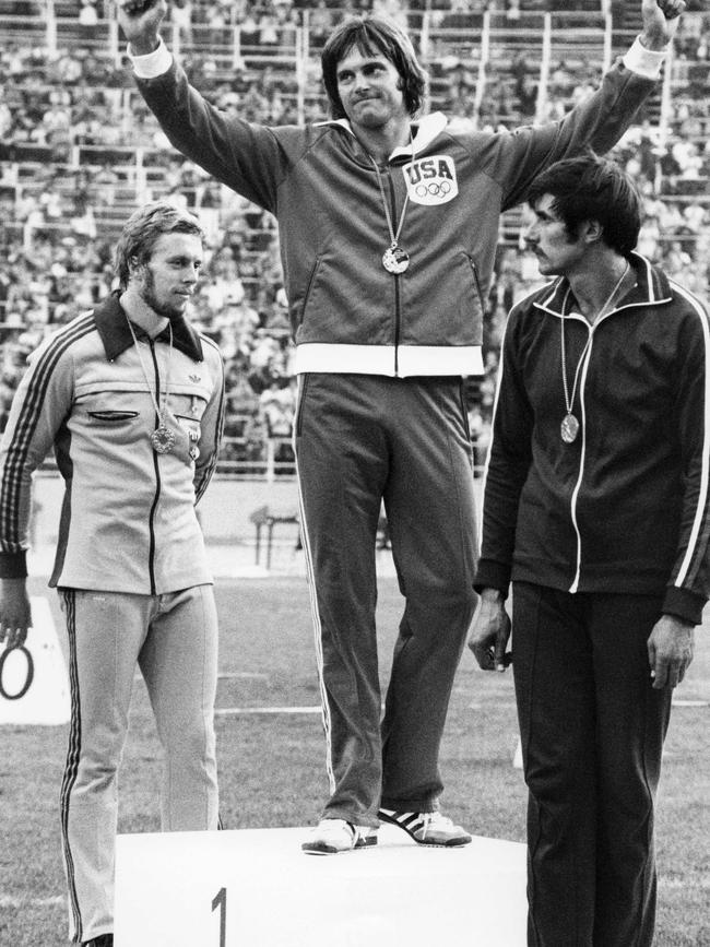 Bruce Jenner (centre) after his gold medal win the men's decathlon competition in 1976. Picture: AFP