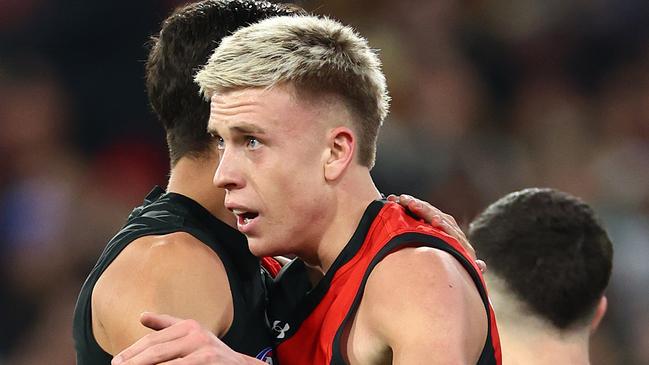 MELBOURNE, AUSTRALIA - JULY 05: Nate Caddy of the Bombers is congratulated by team mates after kicking a goal during the round 17 AFL match between Collingwood Magpies and Essendon Bombers at Melbourne Cricket Ground, on July 05, 2024, in Melbourne, Australia. (Photo by Quinn Rooney/Getty Images)