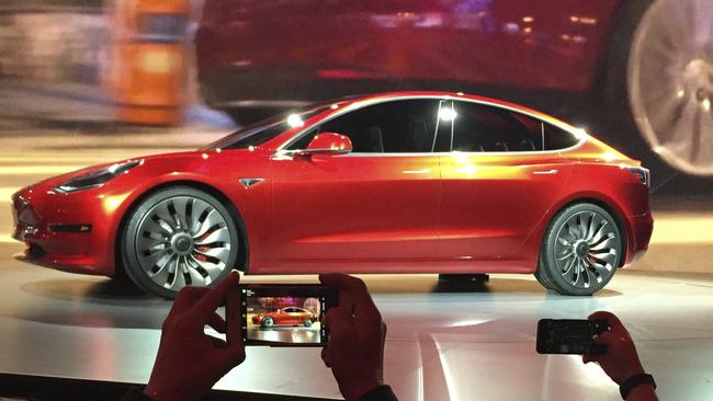 In this March 31, 2016, file photo, Tesla Motors unveils the new lower-priced Model 3 sedan at the Tesla Motors design studio in Hawthorne, Calif. Electric car maker Tesla said on Monday, July 3, 2017, that its Model 3 car will go on sale on Friday. (AP Photo/Justin Pritchard, File)