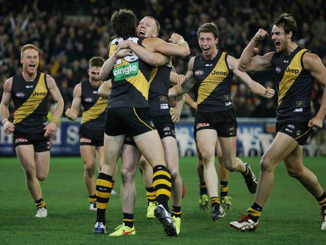 Ivan Maric is mobbed by Richmond teammates following his post-siren goal against Essendon. Picture: Colleen Petch.