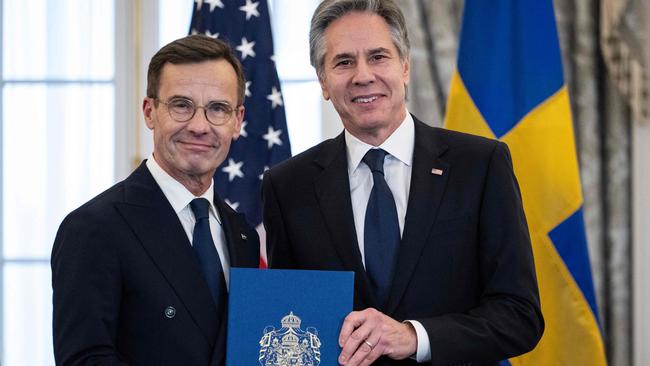 TOPSHOT - US Secretary of State Antony Blinken receives the NATO ratification documents from Swedish Prime Minister Ulf Kristersson during a ceremony at the US State Department, as Sweden formally joins the North Atlantic alliance, in Washington, DC, on March 7, 2024. Kristersson hailed his country's entry into NATO as a "victory for freedom," as it turned the page on two centuries of non-alignment following Russia's invasion of Ukraine. The accession "is a victory for freedom today. Sweden has made a free, democratic, sovereign and united choice to join NATO," he said at the ceremony. (Photo by ANDREW CABALLERO-REYNOLDS / AFP)