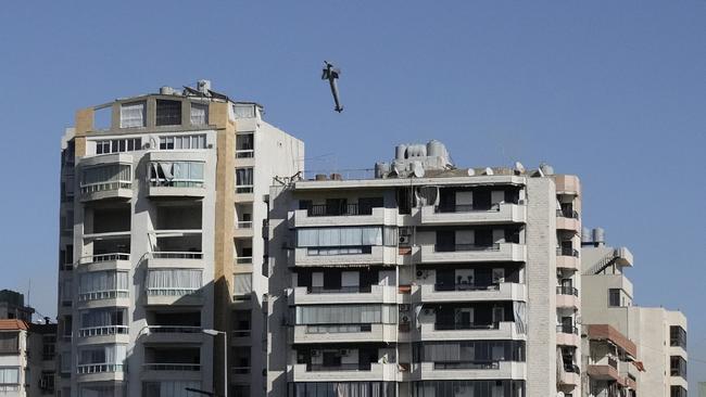 A missile launched from an Israeli jet hones in on a building in Beirut. Picture: AP.