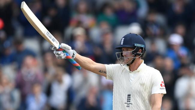 Joe Denly salutes the crowd upon reaching 50. Picture: Getty Images