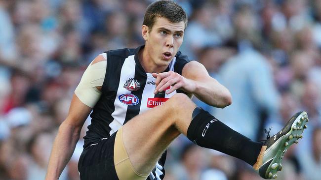 Mason Cox of the Magpies kicks the ball during the round five AFL match between the Collingwood Magpies and the Essendon Bombers.