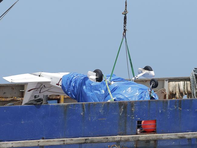 The recovered plane on the deck of the "Kalunda", which brought it up from the sea bed. The plane crashed into the sea off the Tasman Peninsula with a pilot and photographer on board. They were covering the Sydney to Hobart Yacht Race. Picture: LUKE BOWDEN