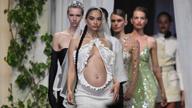 Australian model Shanina Shaik presents an outfit to be auctioned off during the annual amfAR Cinema Against AIDS Cannes Gala. Picture: Stefano Rellandini/AFP