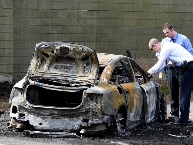 Police at the scene of a burnt out car in Robjant St, Hampton Park, near the scene of a shooting at Nitro Ink tattoo parlour. Picture: AAP/Joe Castro