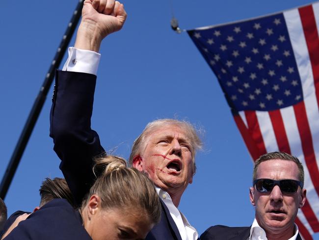 Republican presidential candidate former President Donald Trump is surrounded by U.S. Secret Service agents at a campaign rally, Saturday, July 13, 2024, in Butler, Pa. (AP Photo/Evan Vucci)