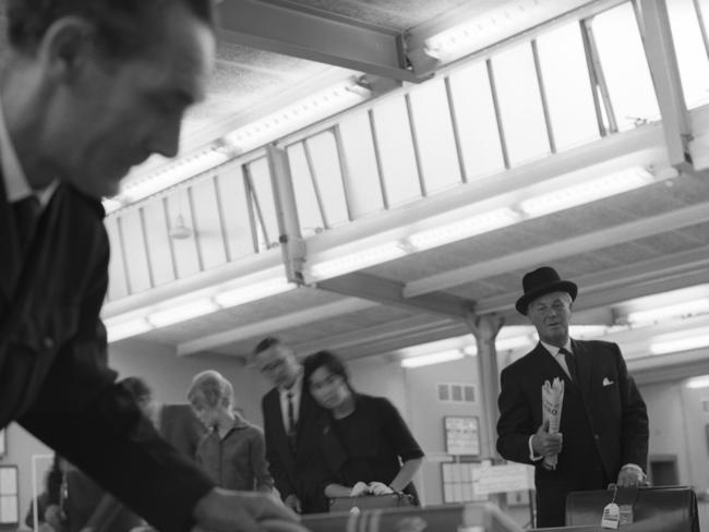 Passengers collect their luggage from a carousel at London Airport (now Heathrow), 1962.